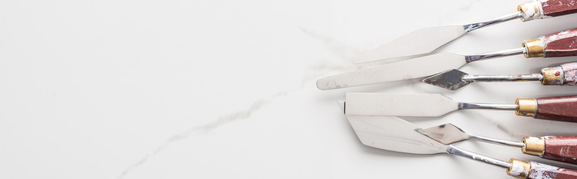 Close-up of artisanal kitchen tools and plated appetizers on marble